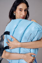 Woman holding a blue weighted blanket with 'Tansy of Tober' branding on a gray background