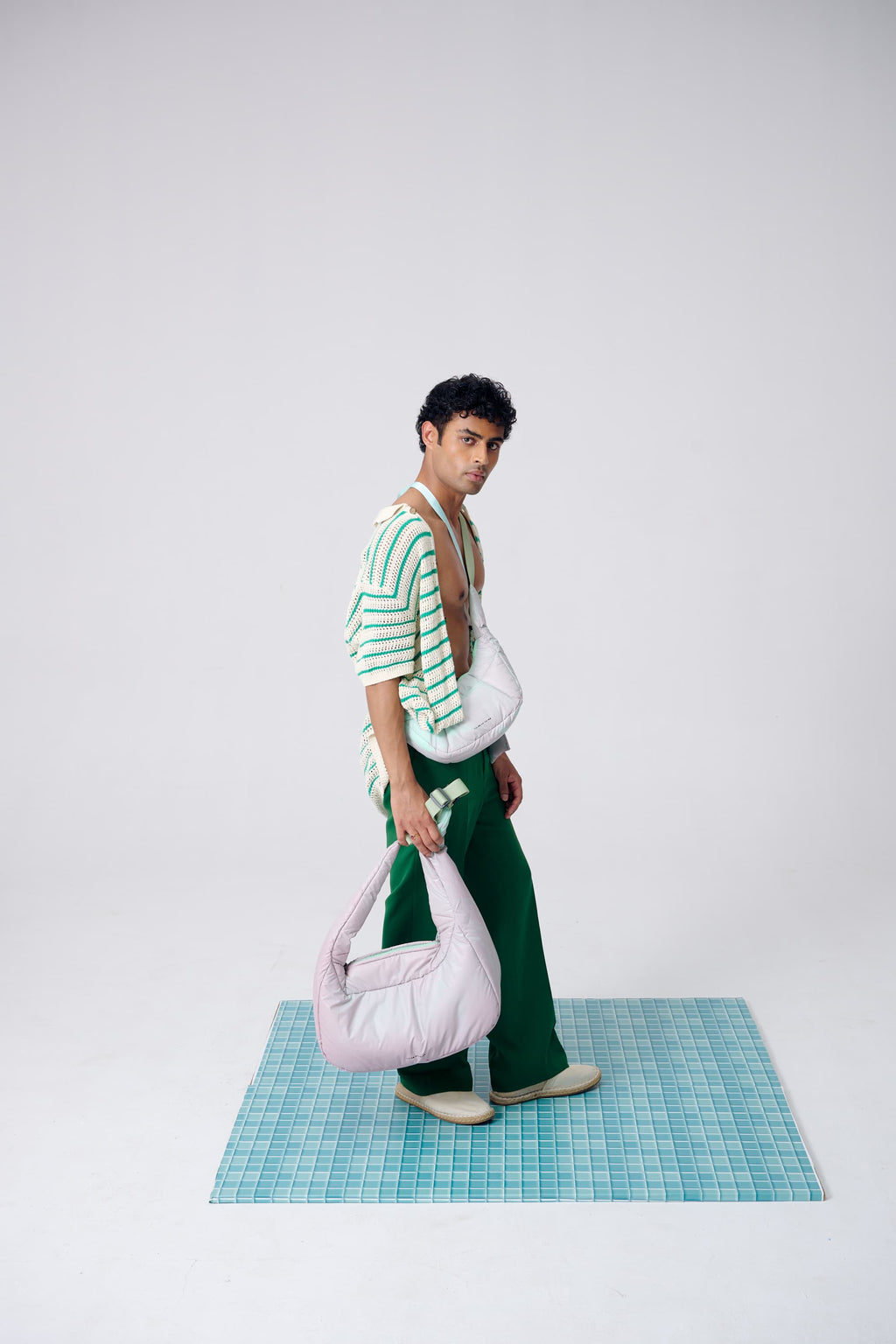 Person holding a pink bag on a white background