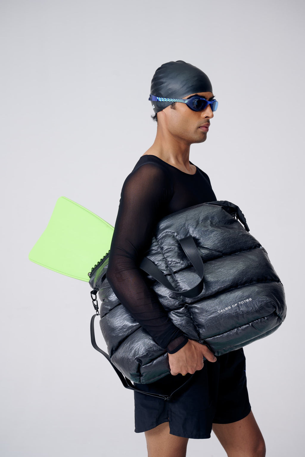 Person holding a large black bag with a white background
