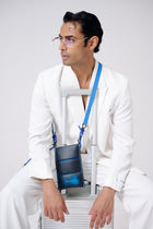 Man in a white suit with a blue bag on a white background
