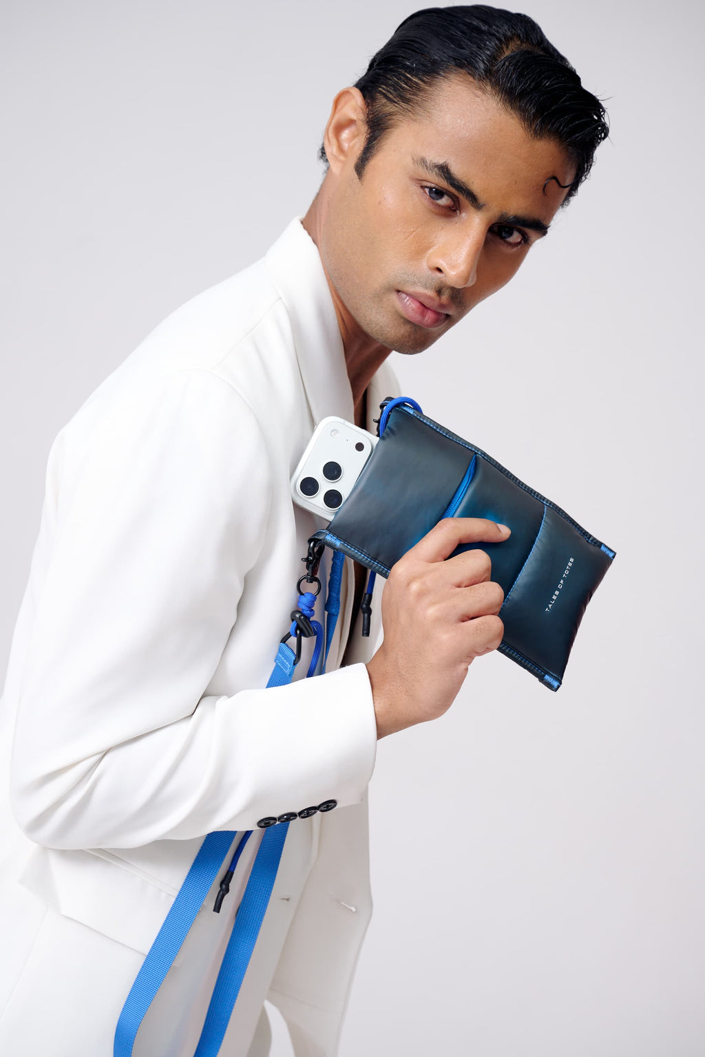Man holding a blue phone case against a white background