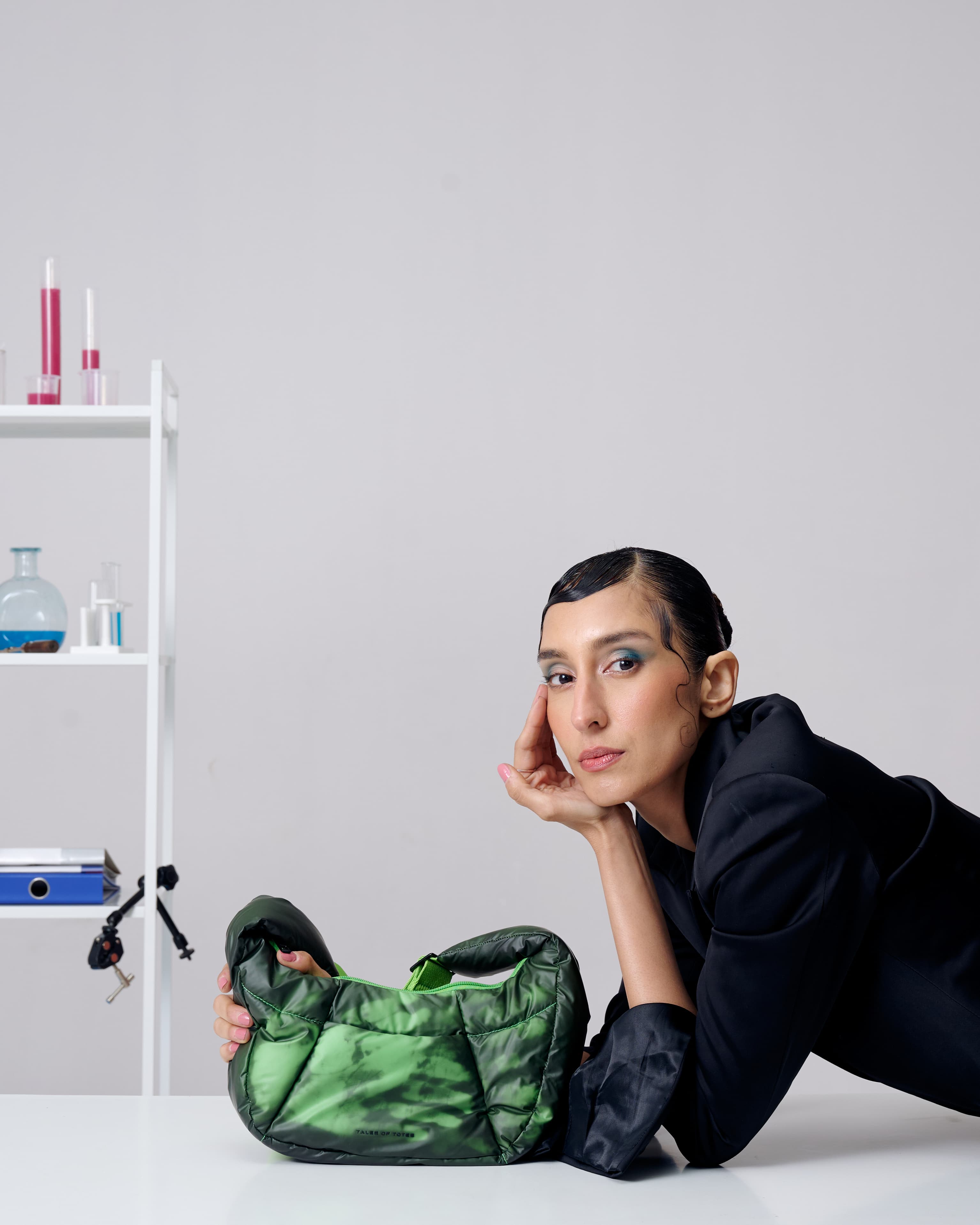 Person holding a green bag with a white background