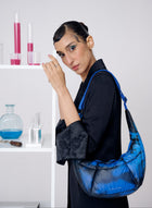 Woman holding a blue bag in a laboratory setting