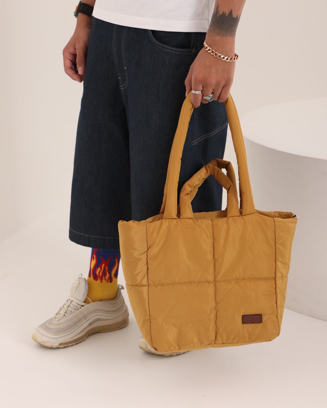 Stylish quilted puffer tote bag with padded handles and box-stitched detailing – ultra-lightweight, roomy, and perfect for everyday use. Ideal for college, shopping, or casual streetwear looks. A trendy fashion essential from Tales of Totes, offering cozy-chic appeal beyond standard canvas bags on Indian platforms like Myntra, Flipkart, and Amazon."