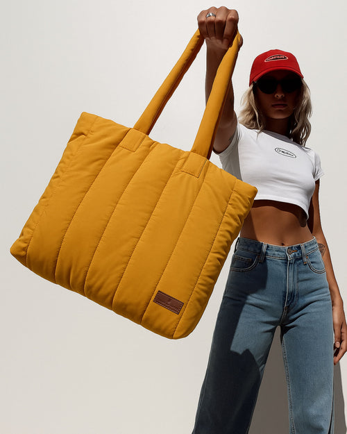 Trendy quilted puffer tote bag with soft padded handles and vertical stitch design – spacious, lightweight, and perfect for daily use, college, travel, or streetwear looks. A bold fashion essential from Tales of Totes, offering comfort and style beyond typical canvas bags on Indian marketplaces like Amazon, Flipkart, and Myntra. Competes with brands like Zouk, Chumbak, and DailyObjects."

