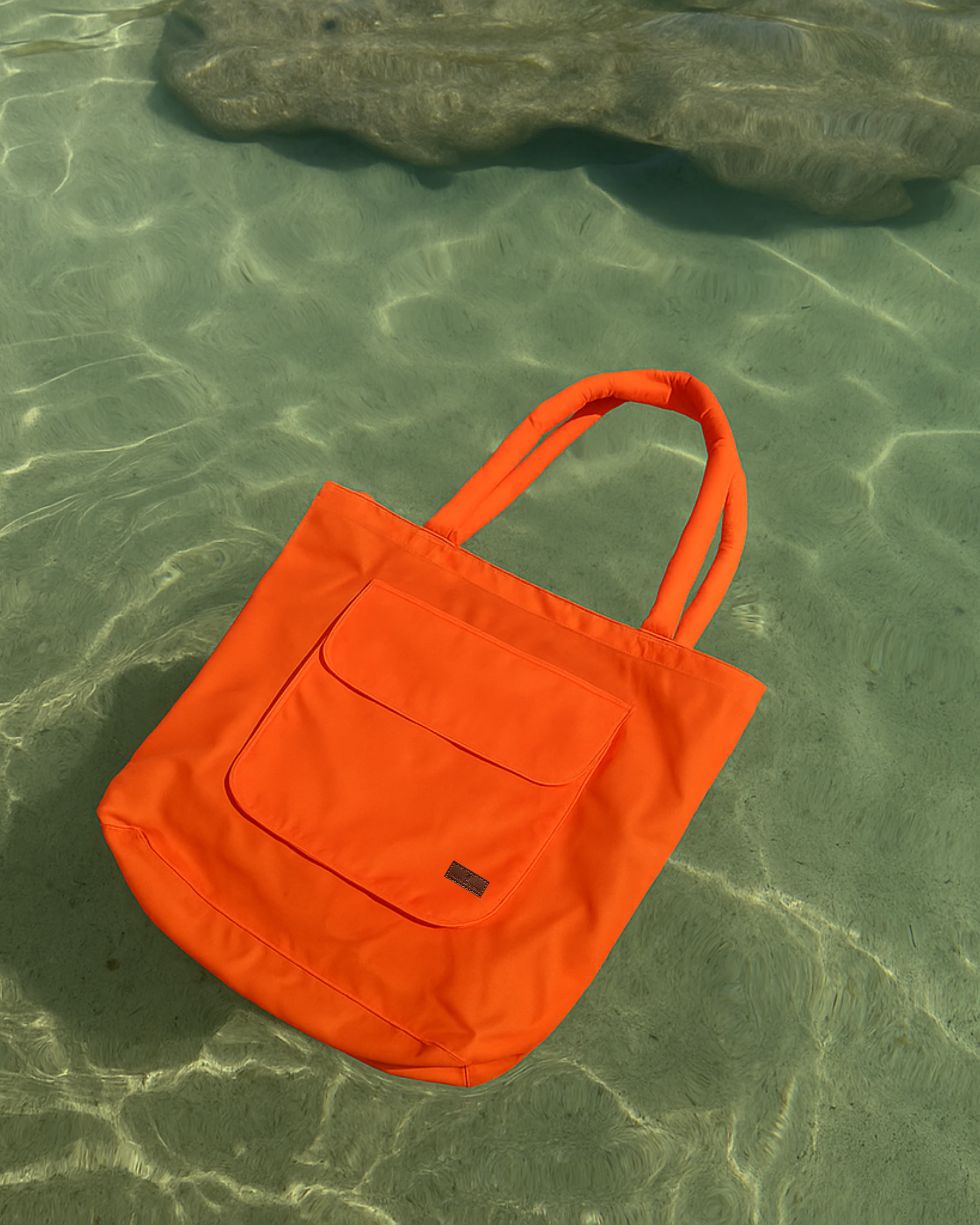 Lightweight nylon tote bag with a padded handle design and front flap pocket – perfect for everyday errands, gym, shopping, or casual travel. Spacious, foldable, and easy to carry with a functional structure that balances fashion and utility. A bold statement piece from Tales of Totes, designed for modern Indian lifestyles and a stylish alternative to basic canvas totes."

