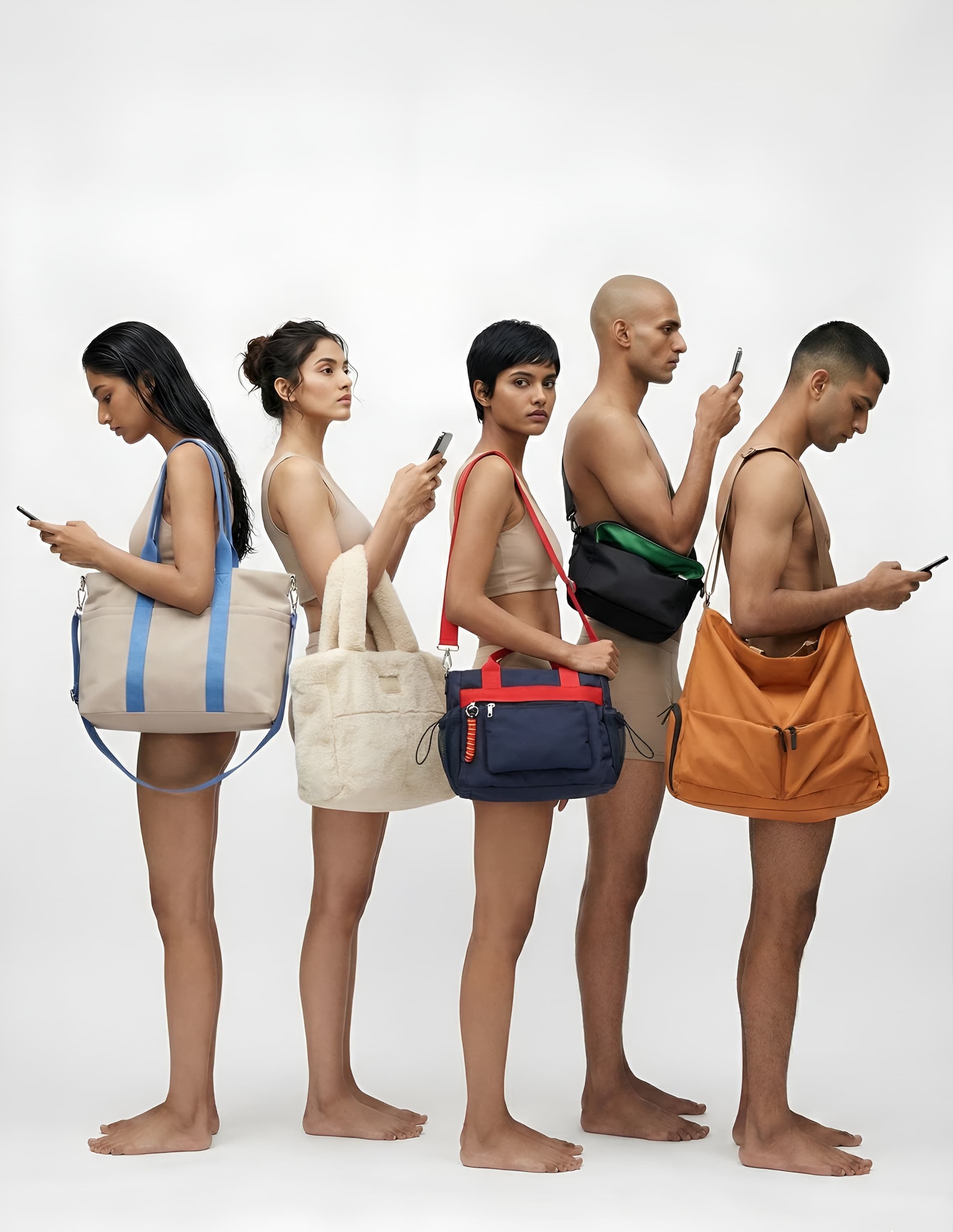 Five people standing side by side, each holding a different colored bag and using a phone.
