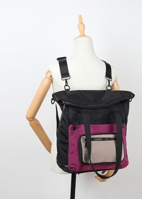 Black and purple backpack on a mannequin against a white background