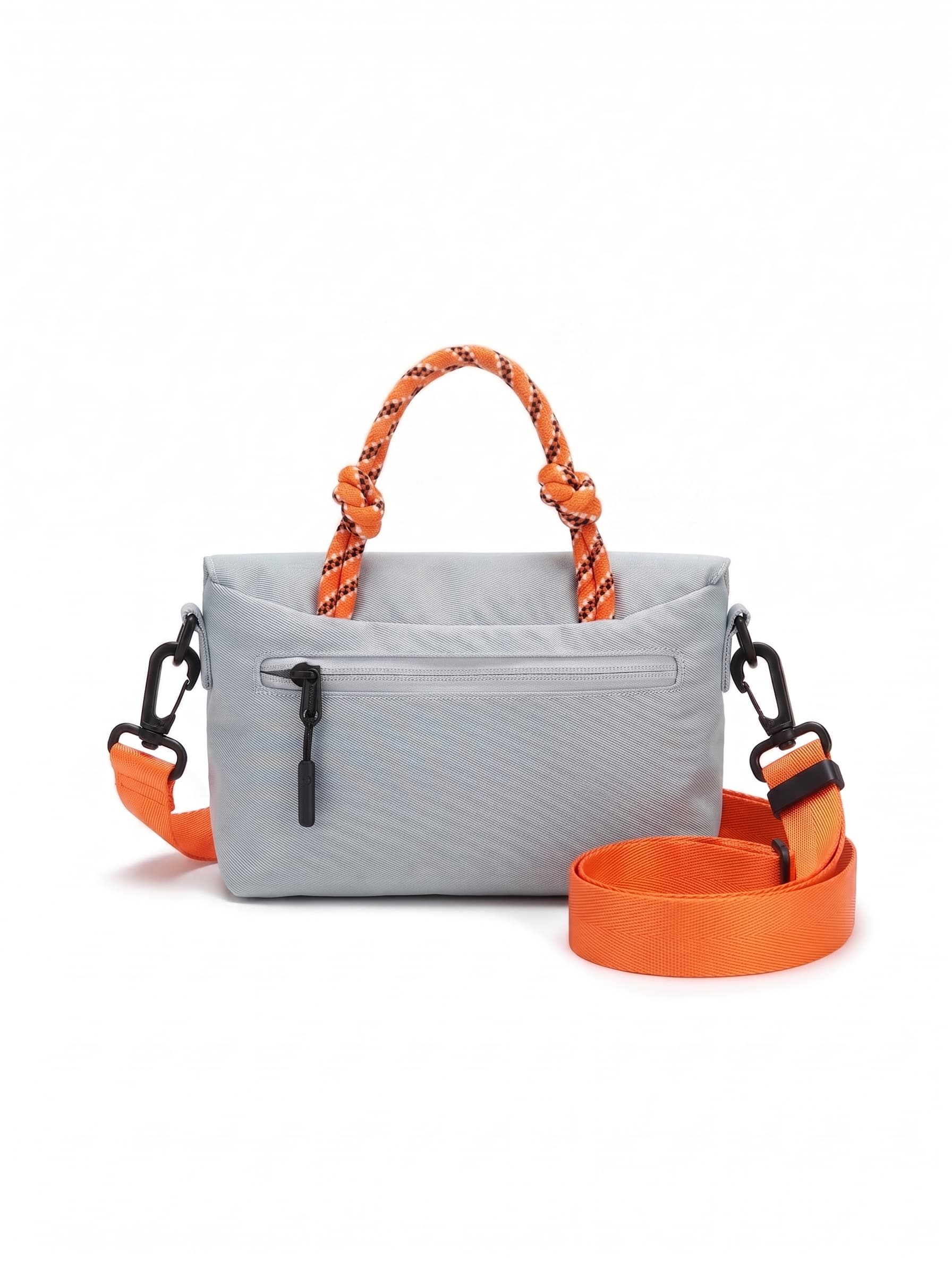 Compact, functional and made to stand out.

Designed for everyday movement, this crossbody bag pairs a clean, softly structured body with contrast utility details. The curved front flap keeps the silhouette minimal, while the bold webbing strap and knotted rope handle give it a sporty, technical edge.

Wear it crossbody for everyday errands, over the shoulder, or carry it by the rope handle when you want to switch things up. Lightweight and easy to style, it’s sized for your daily essentials without feeling