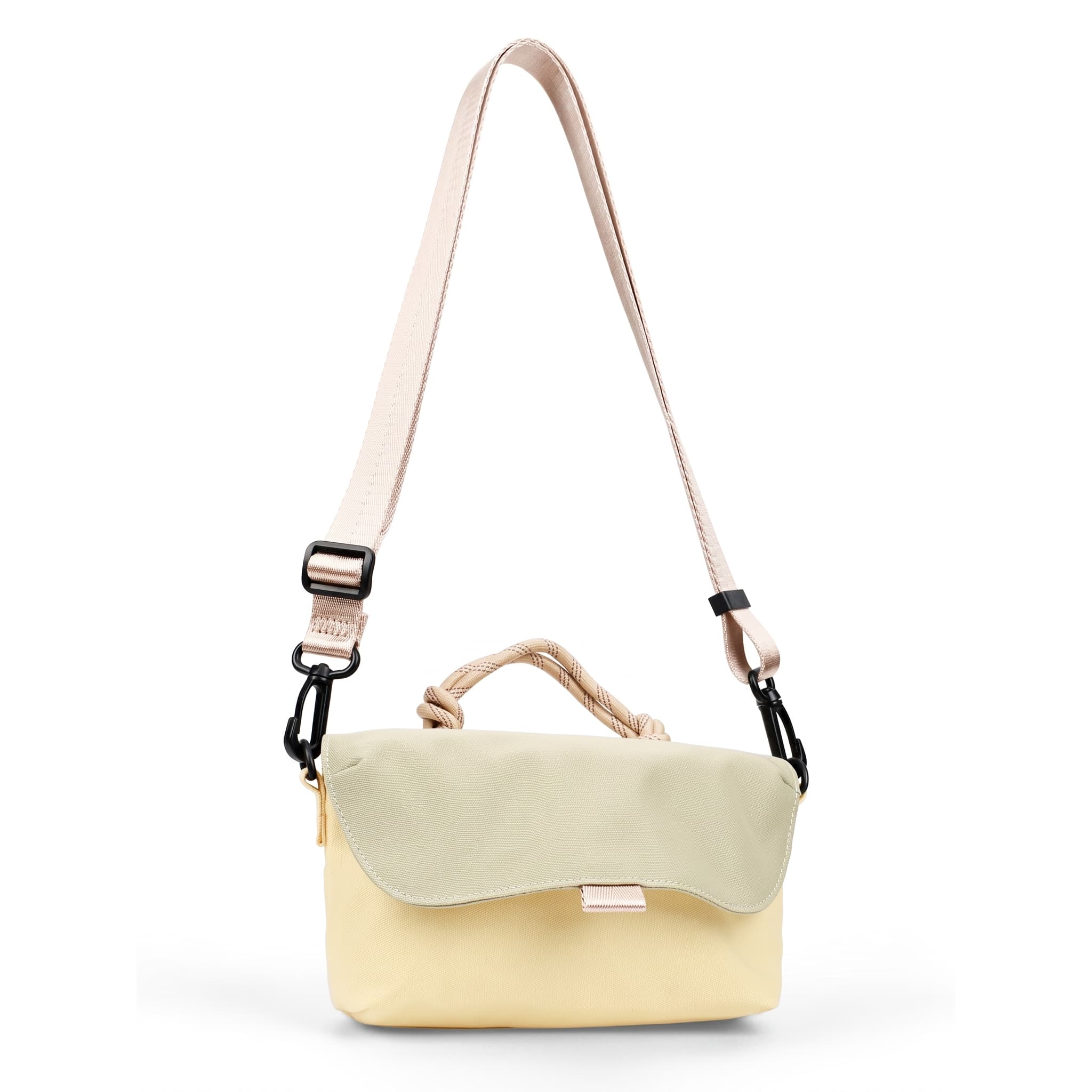 Compact, functional and made to stand out.

Designed for everyday movement, this crossbody bag pairs a clean, softly structured body with contrast utility details. The curved front flap keeps the silhouette minimal, while the bold webbing strap and knotted rope handle give it a sporty, technical edge.

Wear it crossbody for everyday errands, over the shoulder, or carry it by the rope handle when you want to switch things up. Lightweight and easy to style, it’s sized for your daily essentials without feeling