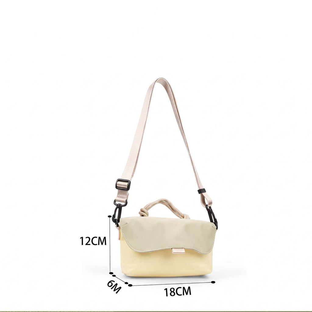 Compact, functional and made to stand out.

Designed for everyday movement, this crossbody bag pairs a clean, softly structured body with contrast utility details. The curved front flap keeps the silhouette minimal, while the bold webbing strap and knotted rope handle give it a sporty, technical edge.

Wear it crossbody for everyday errands, over the shoulder, or carry it by the rope handle when you want to switch things up. Lightweight and easy to style, it’s sized for your daily essentials without feeling