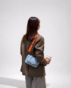 Compact, functional and made to stand out.

Designed for everyday movement, this crossbody bag pairs a clean, softly structured body with contrast utility details. The curved front flap keeps the silhouette minimal, while the bold webbing strap and knotted rope handle give it a sporty, technical edge.

Wear it crossbody for everyday errands, over the shoulder, or carry it by the rope handle when you want to switch things up. Lightweight and easy to style, it’s sized for your daily essentials without feeling