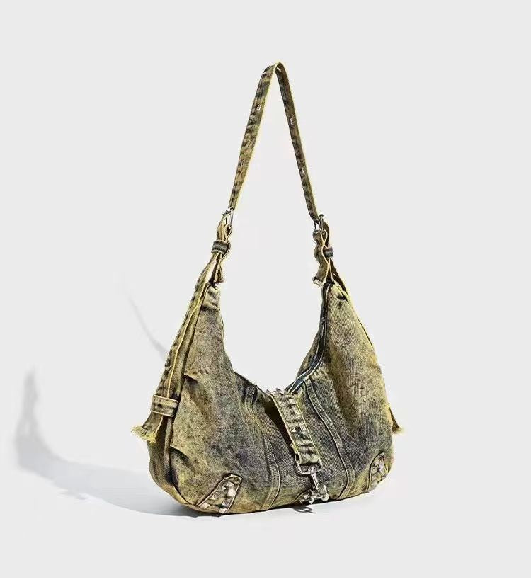 Denim handbag with a strap on a light gray background