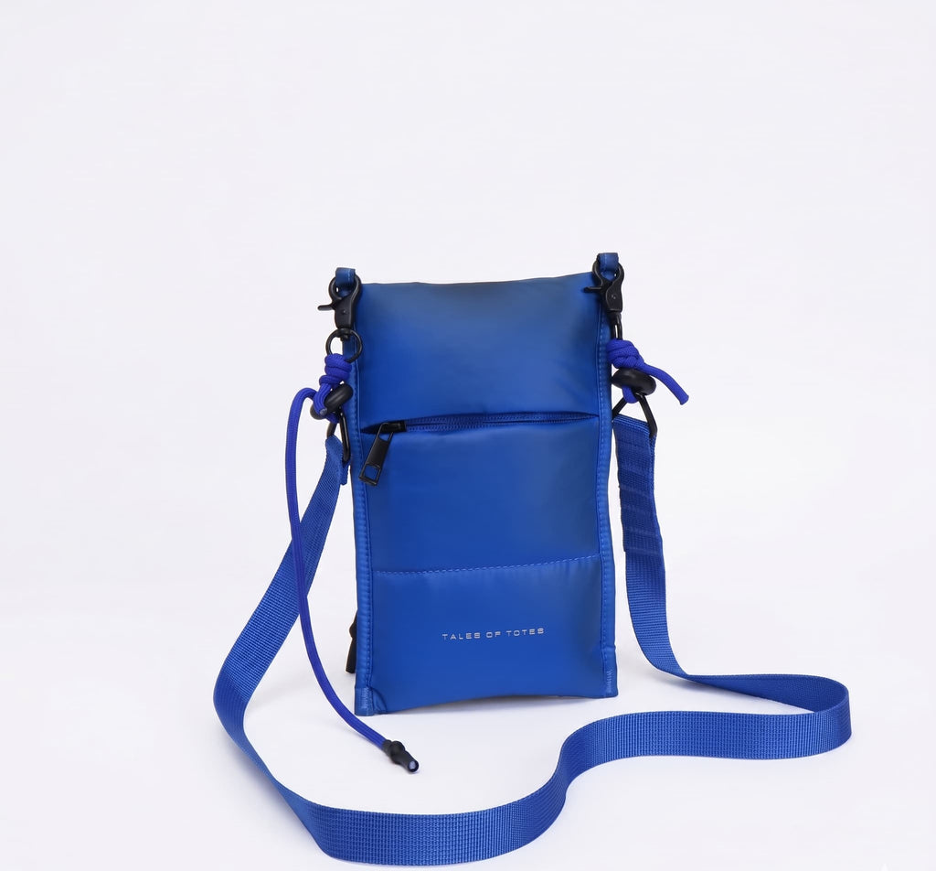 Blue crossbody bag with a strap on a white background