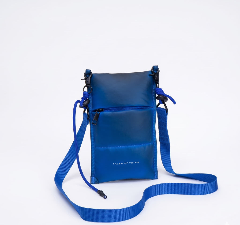 Blue crossbody bag with a strap on a white background