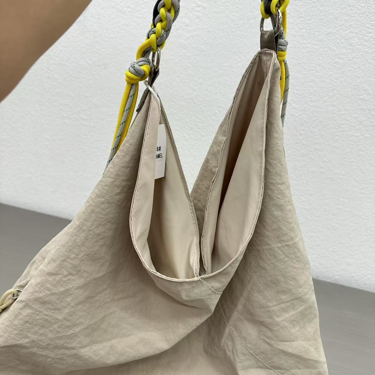 Beige handbag with a braided handle on a white background Person holding a gray tote bag in an indoor setting,“Trendy tote bag for women in India with spacious design, inner pocket, and rope handle strap – perfect everyday alternative to Zara tote bags, H&M shopper bags, Mango handbags, Charles & Keith totes, Lifestyle handbags, Myntra handbags, and Fabindia casual totes.”
