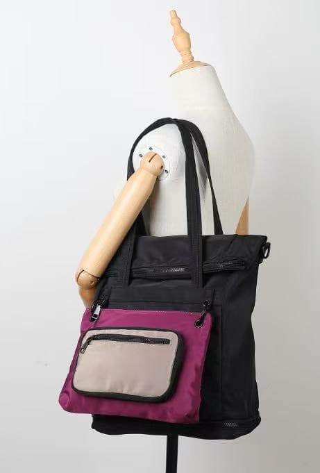 Black and purple tote bag on a mannequin against a white background