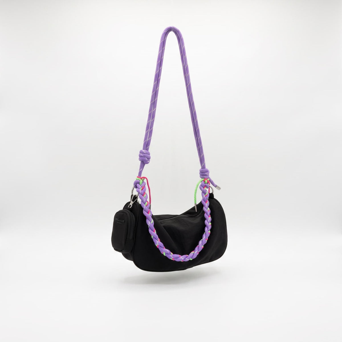 Main image: Daily Loop waterproof nylon hobo bag with braided shoulder handle and removable crossbody strap
Front view: Daily Loop nylon shoulder bag with curved hobo shape and braided rope handle
Side view: Side view of Daily Loop waterproof nylon bag with structured side panel and braided handle
3/4 view: Daily Loop hobo bag in waterproof nylon with braided strap and zip-top closure
Handle detail: Close-up of Daily Loop braided rope handle with contrast cord detailing and metal hardware
Interior view: Int