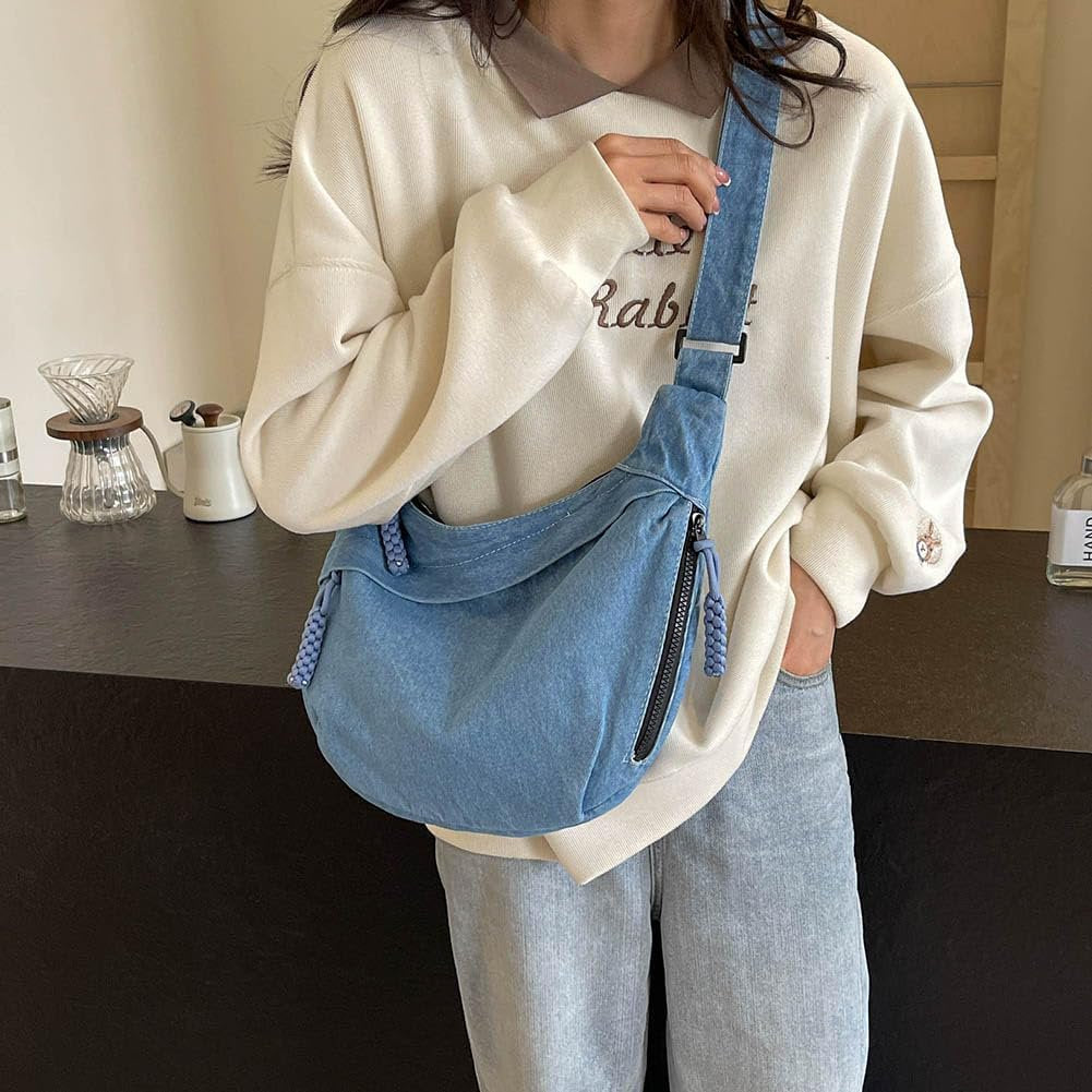Sleek mini tote bag in deep-wash denim, featuring front and side zip pockets and braided pull detailTrendy unisex mini tote bag in deep blue denim with rope zipper details, ideal for Indian streetwear lovers
