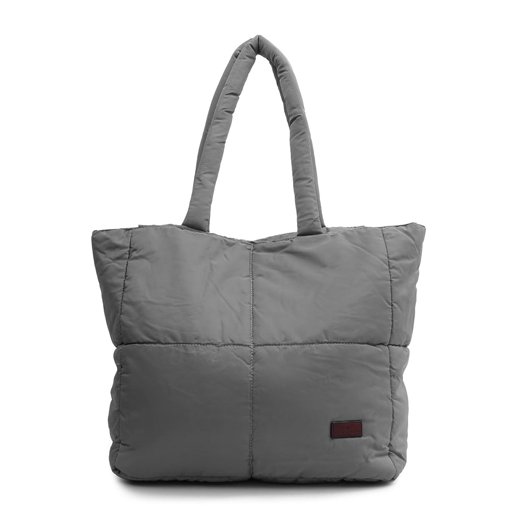 Gray quilted tote bag on a white background Quilted puffer tote bag with padded handles and a soft structured silhouette – lightweight, stylish, and perfect for daily use, college, travel, or shopping. Designed for comfort and statement appeal, this spacious carryall from Tales of Totes is a trendy alternative to Zouk, Lavie, and DailyObjects in India’s fashion accessories market."