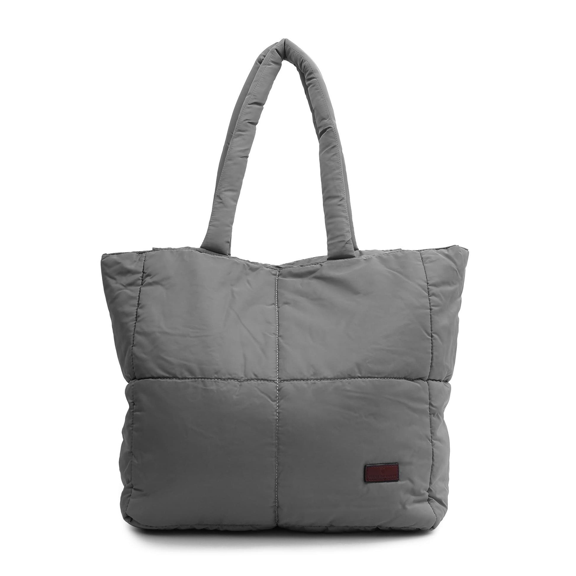 Gray quilted tote bag on a white background Quilted puffer tote bag with padded handles and a soft structured silhouette – lightweight, stylish, and perfect for daily use, college, travel, or shopping. Designed for comfort and statement appeal, this spacious carryall from Tales of Totes is a trendy alternative to Zouk, Lavie, and DailyObjects in India’s fashion accessories market."