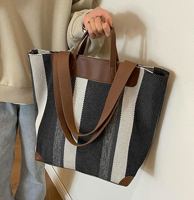 "Eco-friendly striped jute tote bag with dual handles – featuring bold black, grey, and white vertical patterns with leather-look accents and brown straps. Ideal for shopping, office, and casual outings. A sustainable and stylish choice from Tales of Totes – offering earthy, durable fashion accessories that stand apart from brands like Chumbak, Baggit, and DailyObjects in the Indian market."

