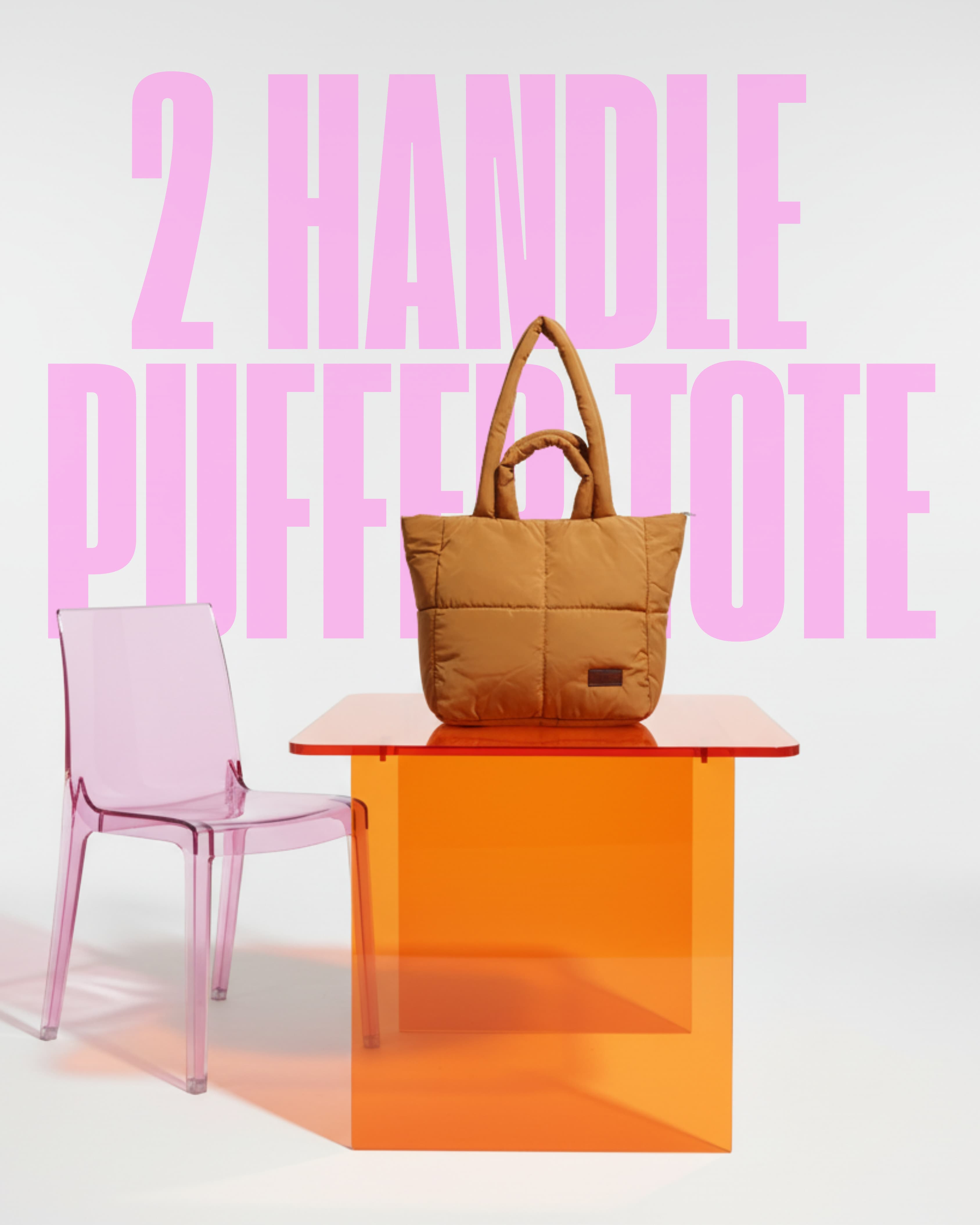 Brown tote bag on a transparent orange table with pink chair and text '2 HANDLE PUFFED TOTE' in the background.Stylish quilted puffer tote bag with padded handles and box-stitched detailing – ultra-lightweight, roomy, and perfect for everyday use. Ideal for college, shopping, or casual streetwear looks. A trendy fashion essential from Tales of Totes, offering cozy-chic appeal beyond standard canvas bags on Indian platforms like Myntra, Flipkart, and Amazon."