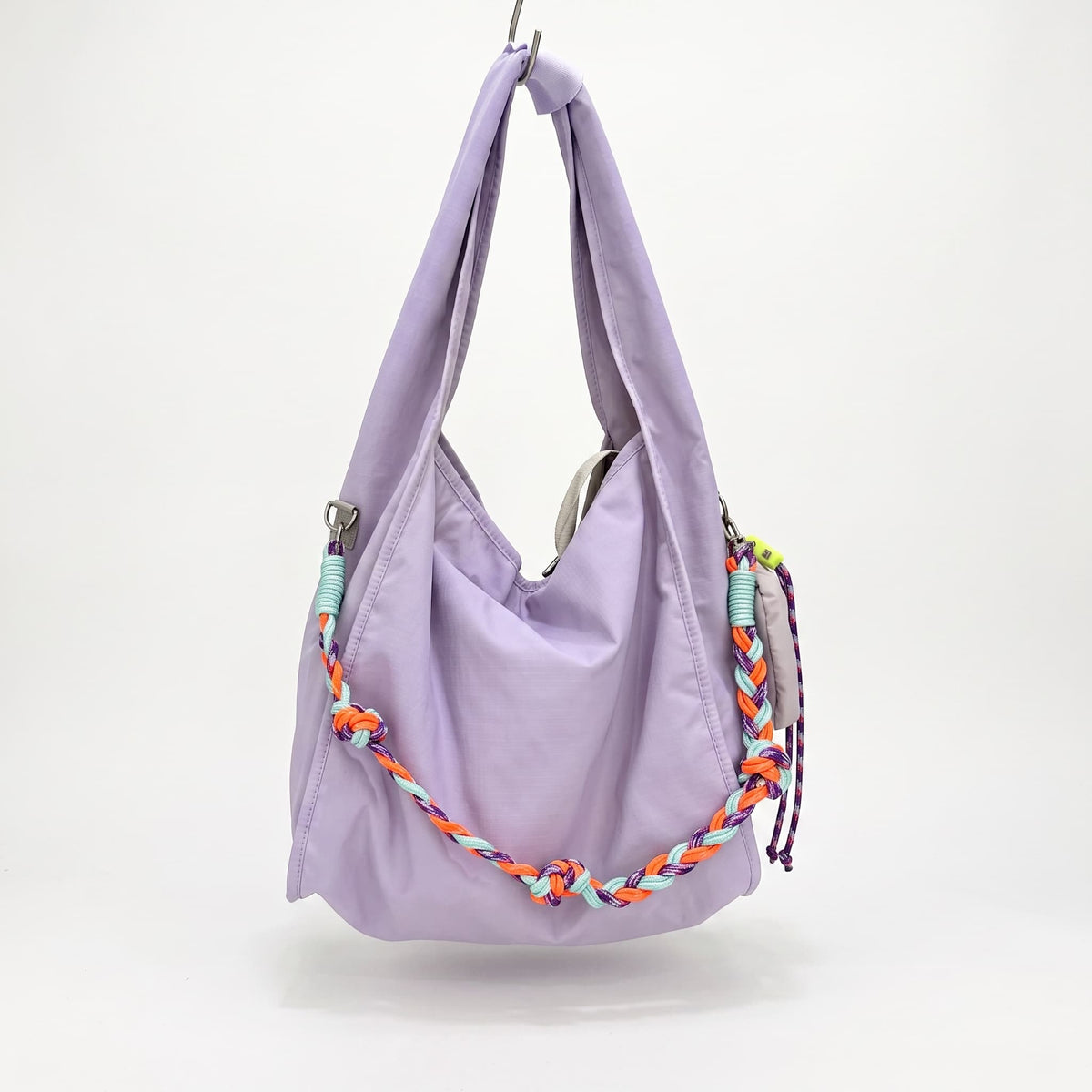 Waterproof nylon hobo bag with wide shoulder handle, removable braided crossbody strap and detachable mini pouch