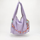 Waterproof nylon hobo bag with wide shoulder handle, removable braided crossbody strap and detachable mini pouch