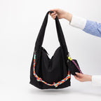 Waterproof nylon hobo bag with wide shoulder handle, removable braided crossbody strap and detachable mini pouch