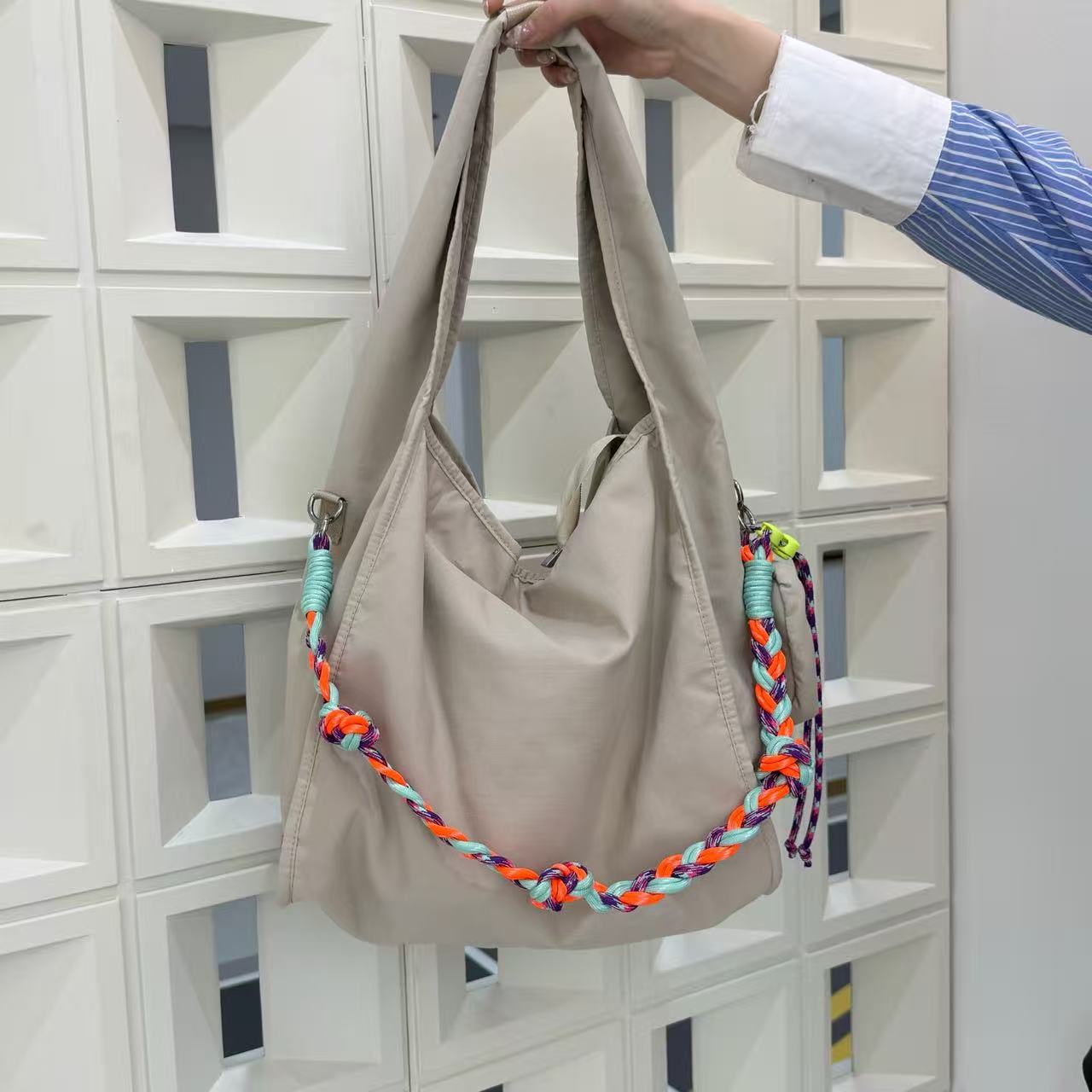 Waterproof nylon hobo bag with wide shoulder handle, removable braided crossbody strap and detachable mini pouch