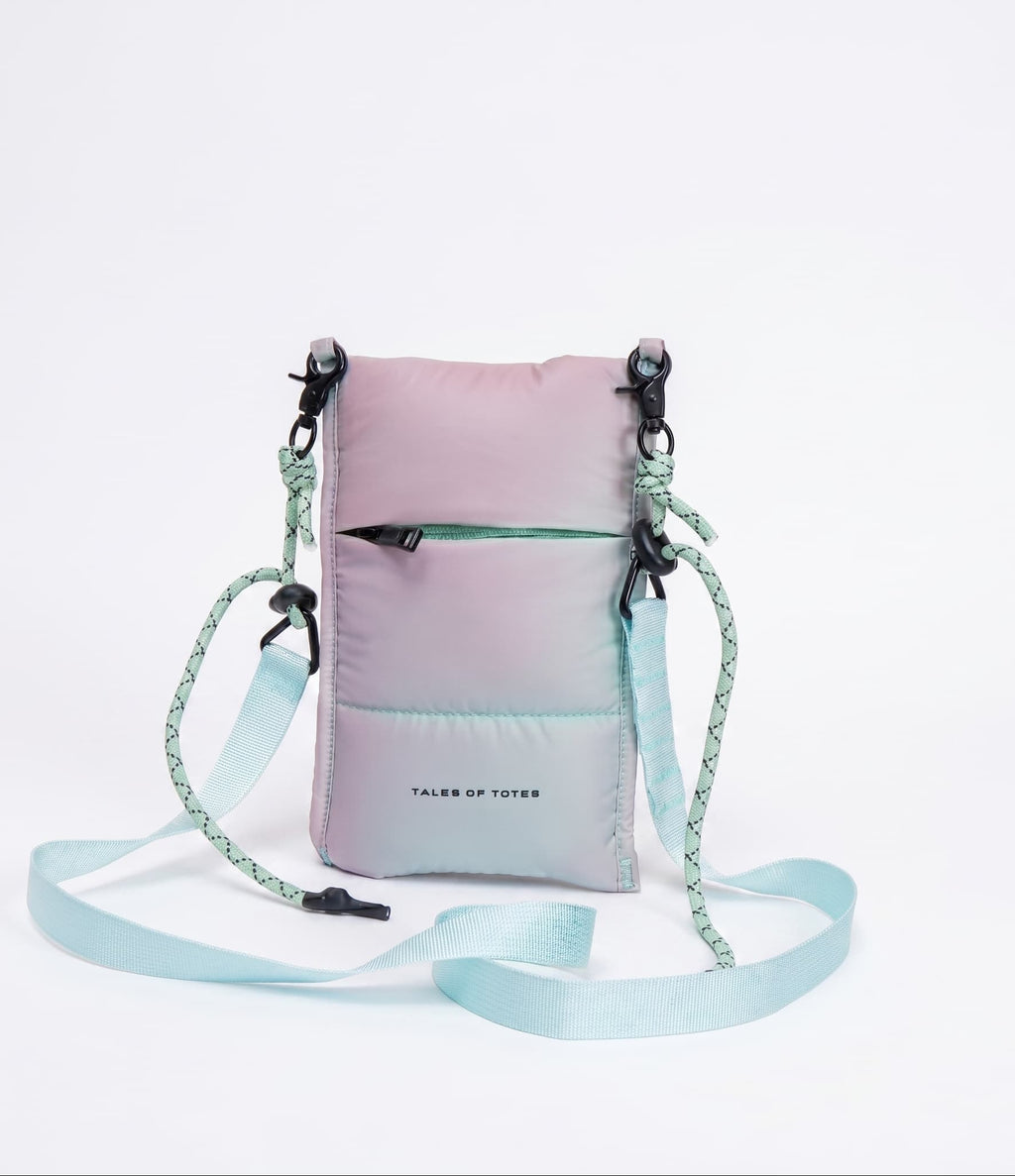 Gradient pink to blue crossbody bag with a strap on a light gray background