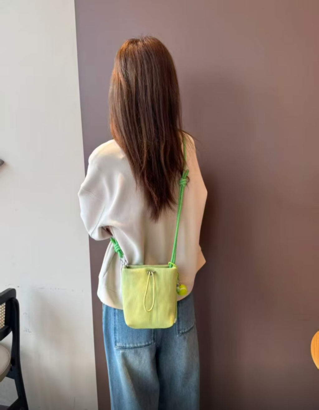 Small in size, strong in character.

This compact sling bag is built around a tall, bucket-style silhouette with a tactile textured outer body and a soft drawstring inner pouch. The long rope strap keeps the look relaxed and functional, while knotted details and utility hardware give it a more experimental feel than a conventional mini bag.

Designed for days when you only want to carry the essentials, it sits comfortably against the body without feeling bulky. The narrow shape keeps it easy to move around 
