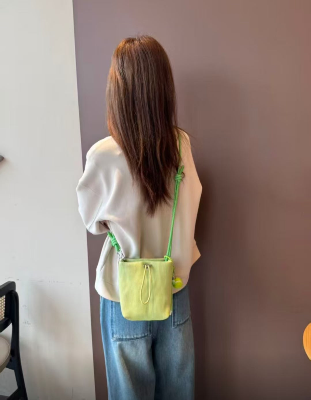 Small in size, strong in character.

This compact sling bag is built around a tall, bucket-style silhouette with a tactile textured outer body and a soft drawstring inner pouch. The long rope strap keeps the look relaxed and functional, while knotted details and utility hardware give it a more experimental feel than a conventional mini bag.

Designed for days when you only want to carry the essentials, it sits comfortably against the body without feeling bulky. The narrow shape keeps it easy to move around 
