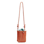 Small in size, strong in character.

This compact sling bag is built around a tall, bucket-style silhouette with a tactile textured outer body and a soft drawstring inner pouch. The long rope strap keeps the look relaxed and functional, while knotted details and utility hardware give it a more experimental feel than a conventional mini bag.

Designed for days when you only want to carry the essentials, it sits comfortably against the body without feeling bulky. The narrow shape keeps it easy to move around 