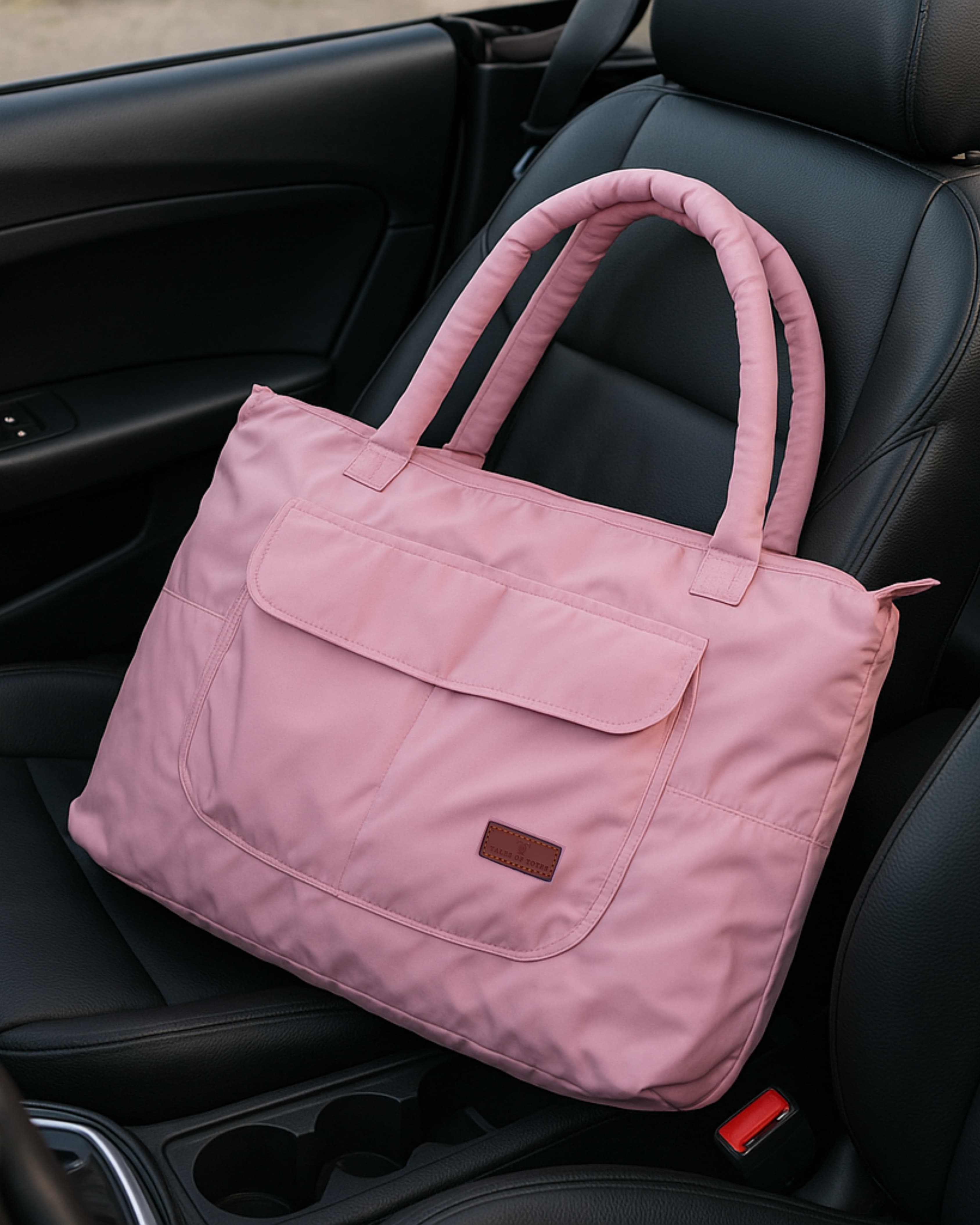 Lightweight nylon tote bag with a padded handle design and front flap pocket – perfect for everyday errands, gym, shopping, or casual travel. Spacious, foldable, and easy to carry with a functional structure that balances fashion and utility. A bold statement piece from Tales of Totes, designed for modern Indian lifestyles and a stylish alternative to basic canvas totes."

