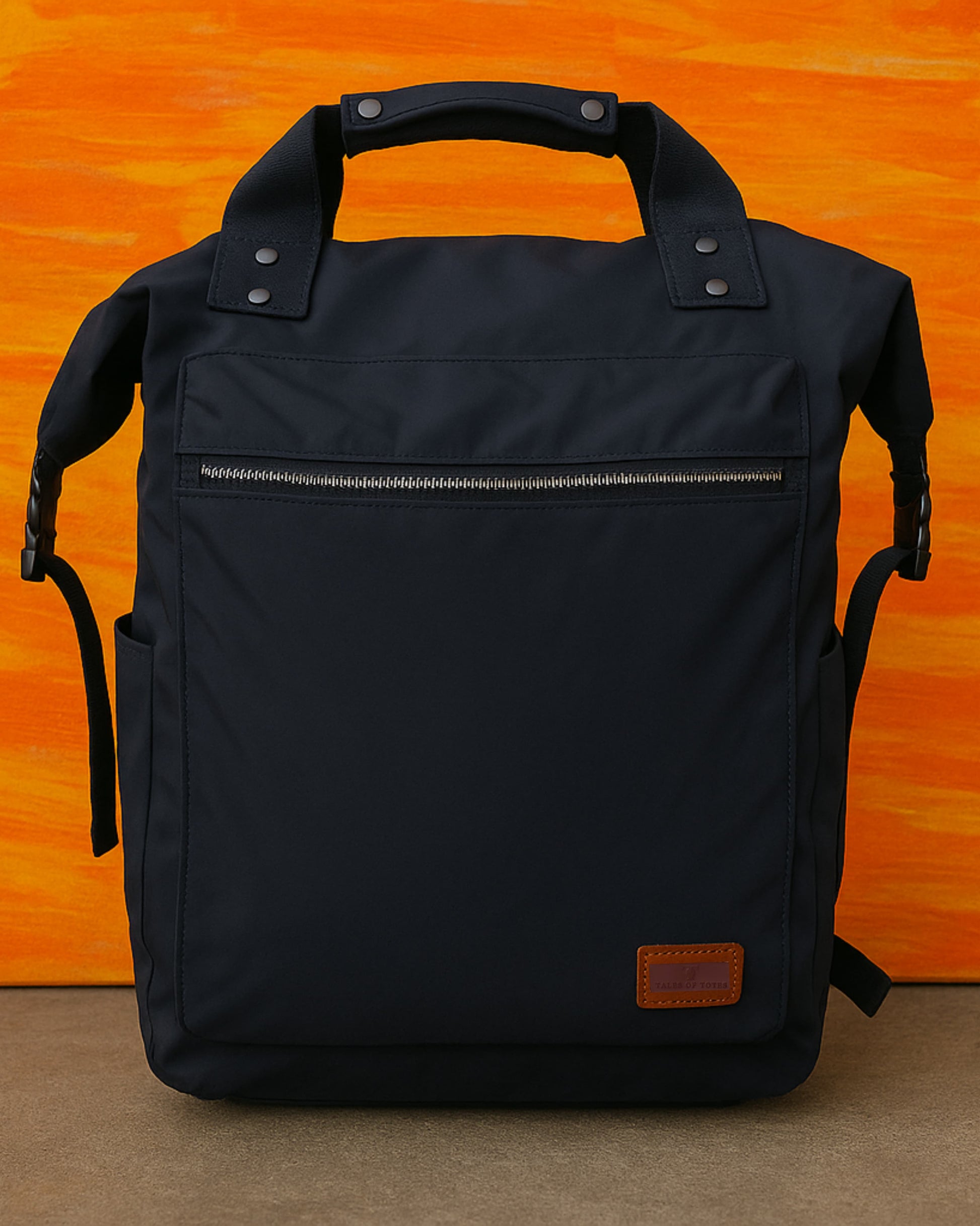 "Modern utility backpack with a structured silhouette, front zip pocket, padded handle, and side compartments – designed for daily commuting, travel, or college use. Features durable water-resistant material, sleek zipper details, and adjustable shoulder straps. A functional and fashion-forward choice from Tales of Totes for urban Indian lifestyles."

