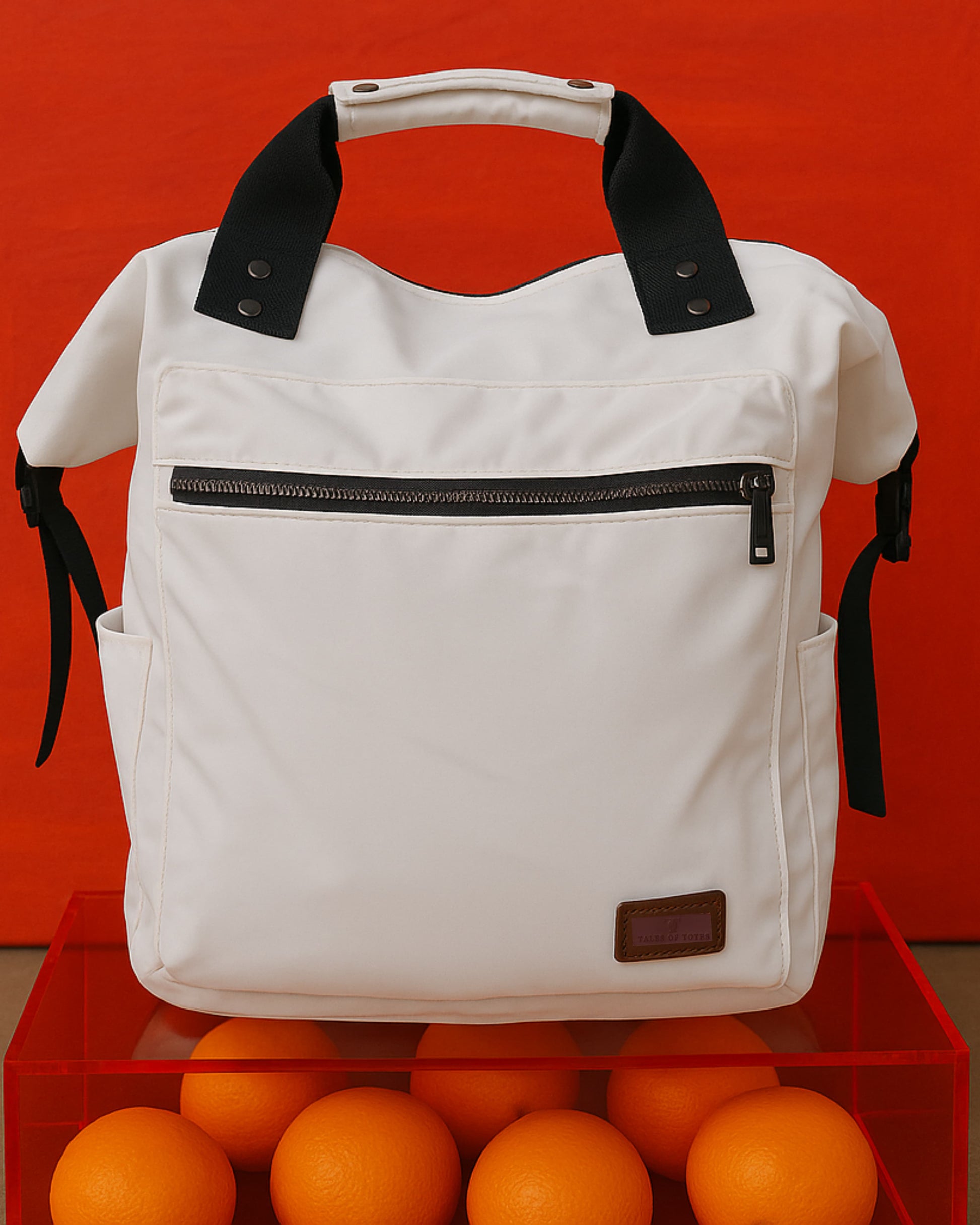 "Modern utility backpack with a structured silhouette, front zip pocket, padded handle, and side compartments – designed for daily commuting, travel, or college use. Features durable water-resistant material, sleek zipper details, and adjustable shoulder straps. A functional and fashion-forward choice from Tales of Totes for urban Indian lifestyles."


