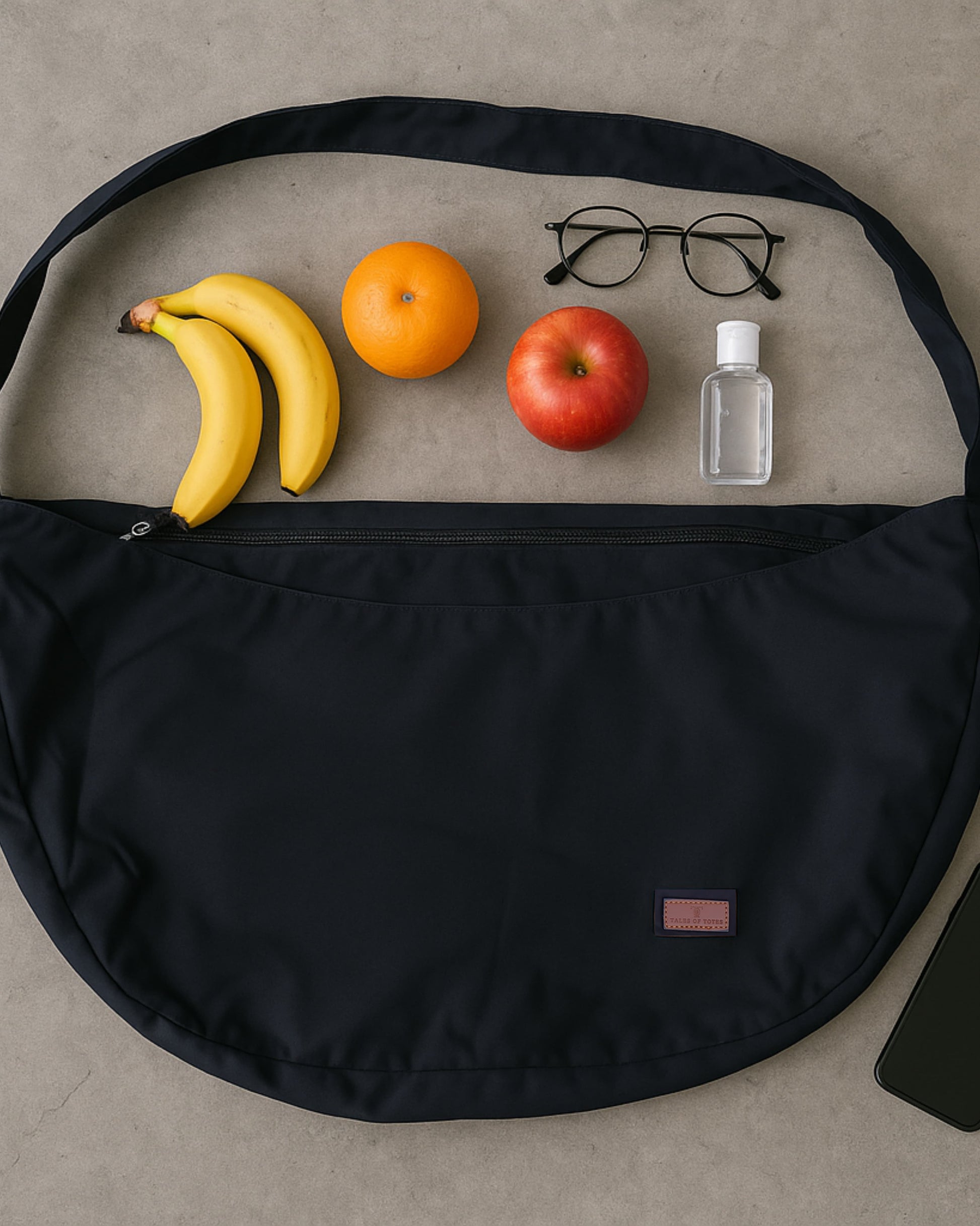 Half-moon shaped crossbody tote bag made from lightweight, water-resistant fabric – features a wide adjustable strap and secure top zipper closure. Minimalist design ideal for everyday carry, travel, or streetwear looks. A functional and fashion-forward piece from Tales of Totes, offering elevated casual utility for modern Indian shoppers."