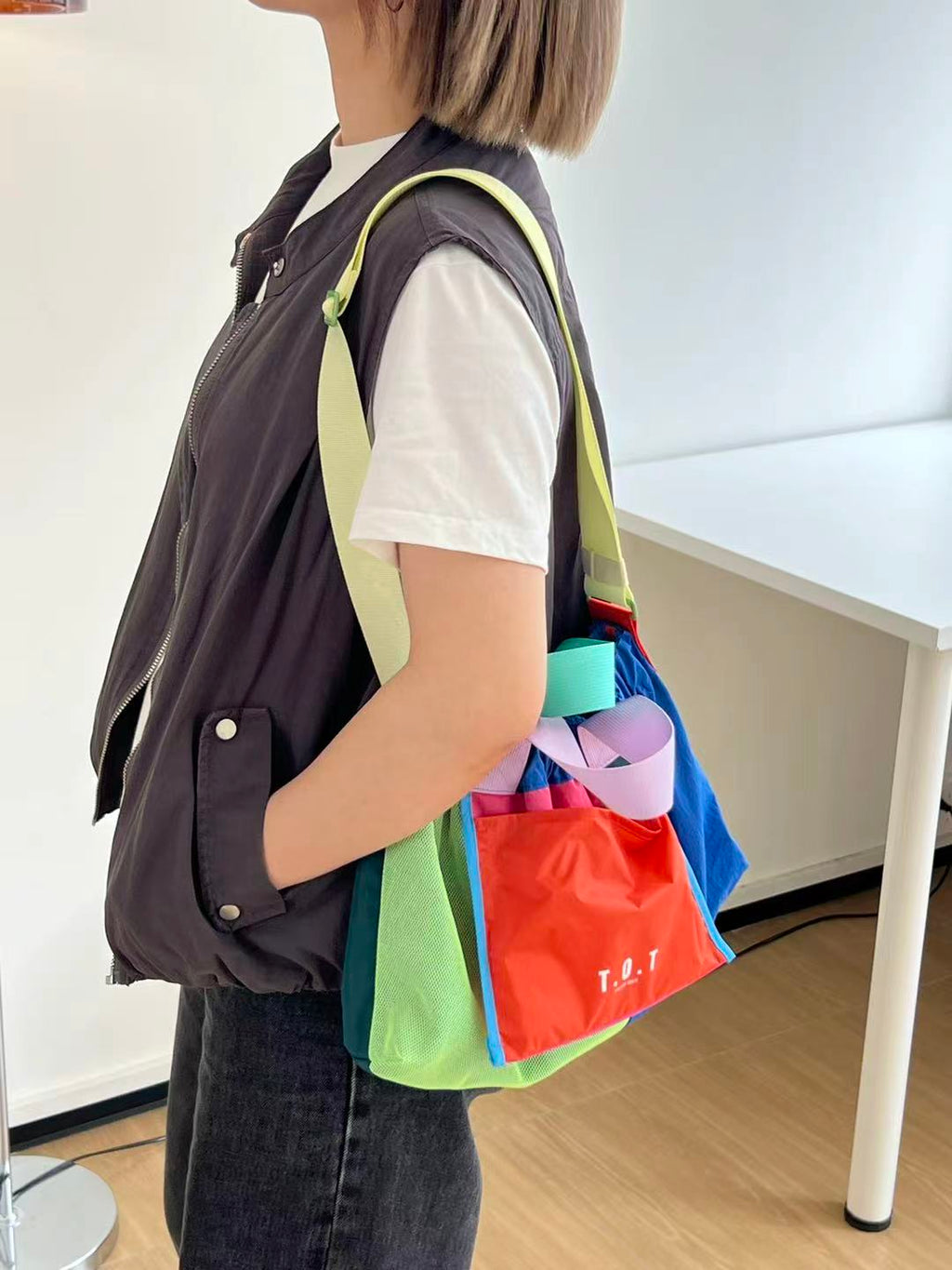 Trendy multi-color casual college tote bag with mesh detailing and adjustable straps.