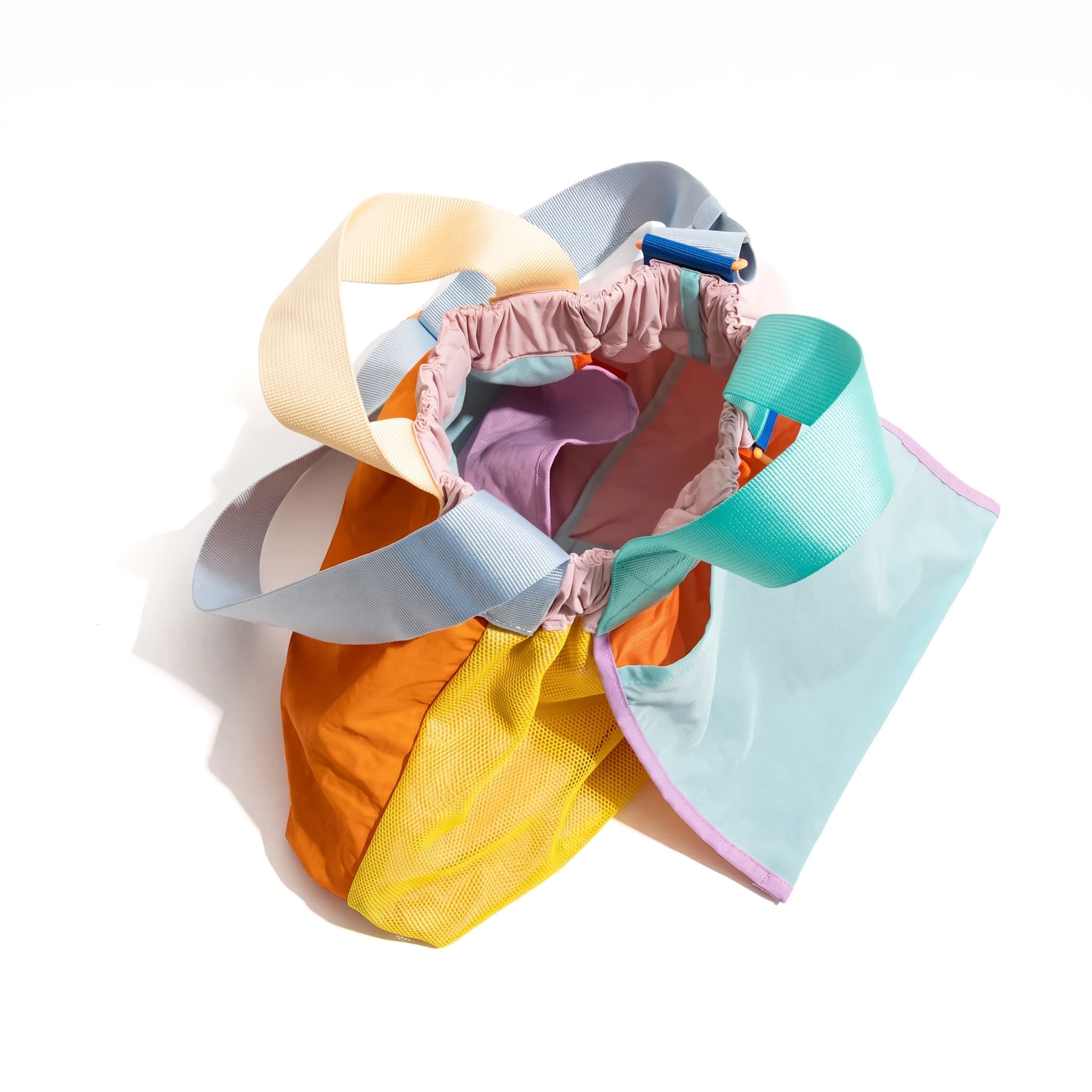Trendy multi-color casual college tote bag with mesh detailing and adjustable straps.