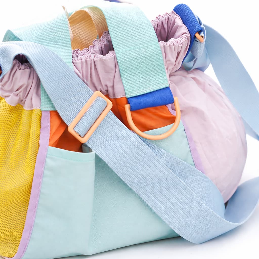 Colorful baby seat with pastel straps on a white background