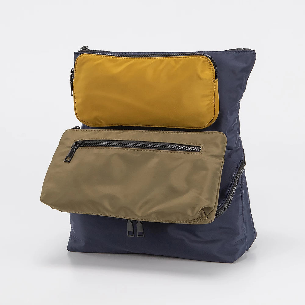 Multicolored backpack with yellow, brown, and navy sections on a white background