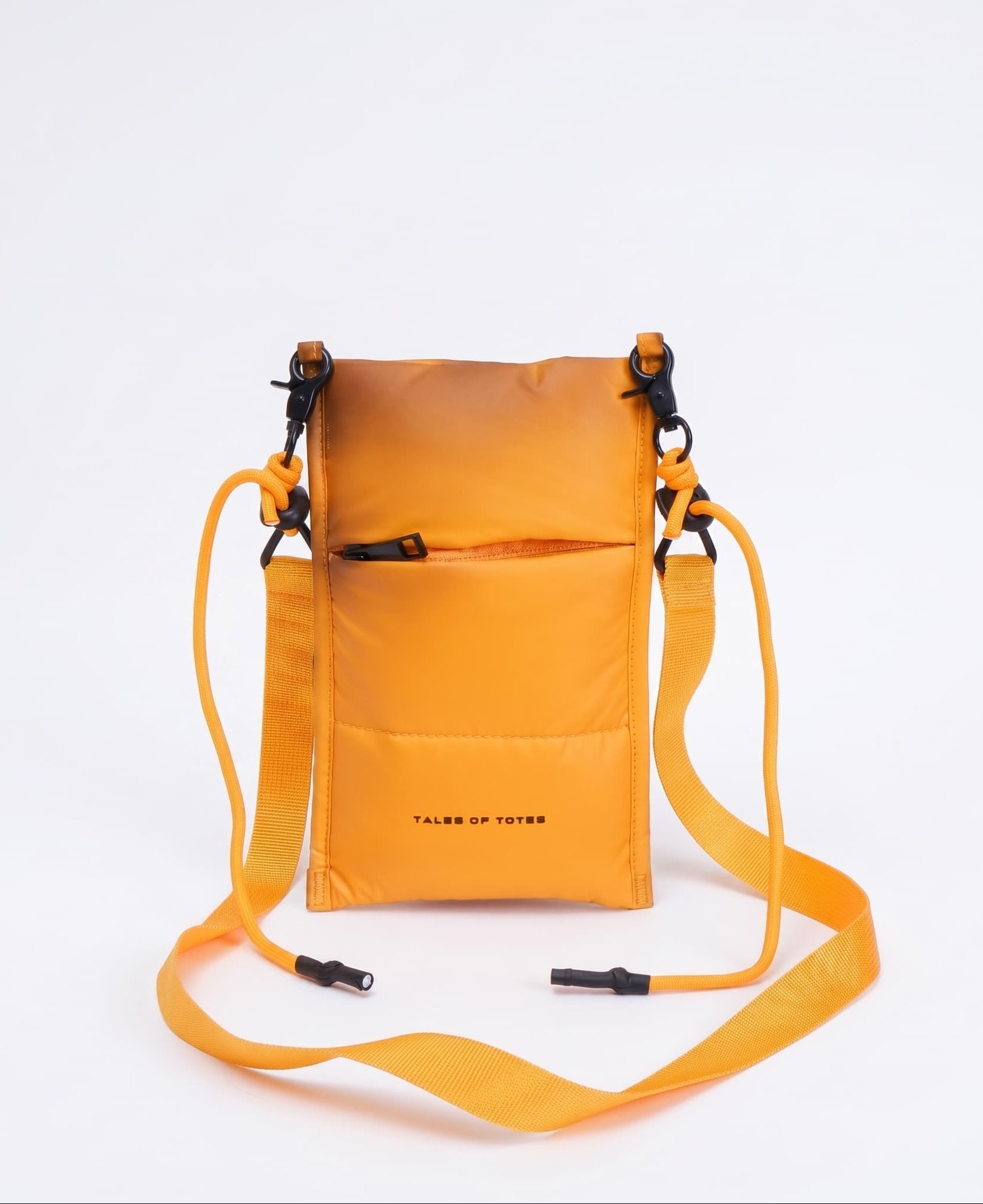 Orange crossbody bag with a strap on a white background