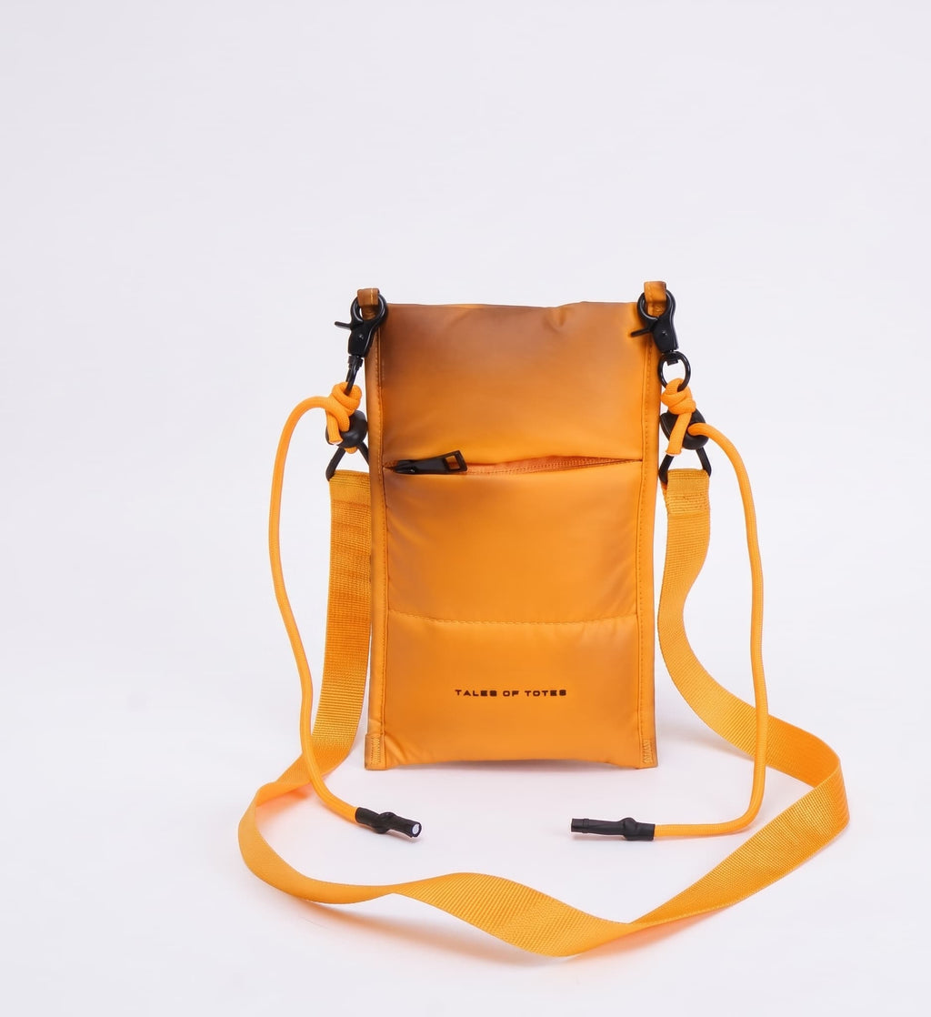Orange crossbody bag with a strap on a white background