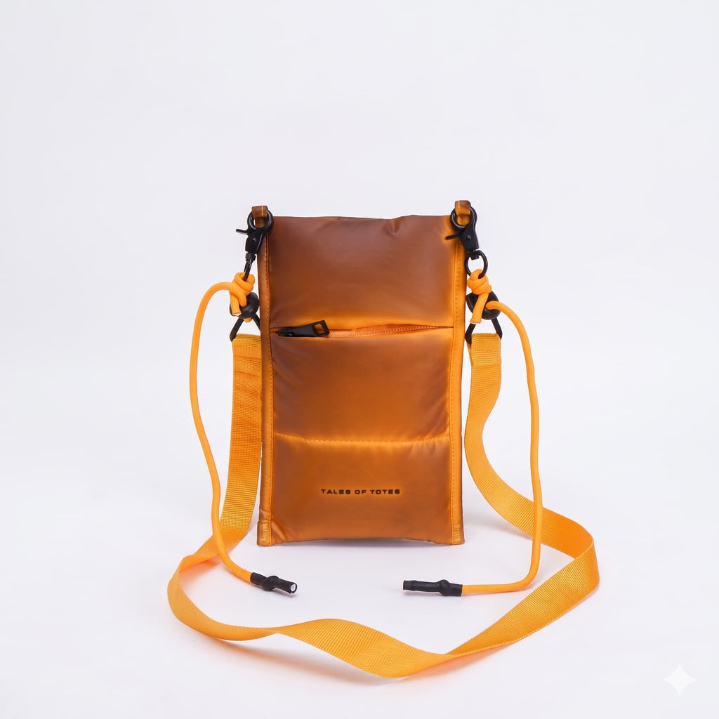 Orange crossbody bag with a strap on a white background